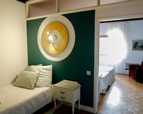 a bedroom with a bed and a wall with a donut on it at Terrace House in Braga
