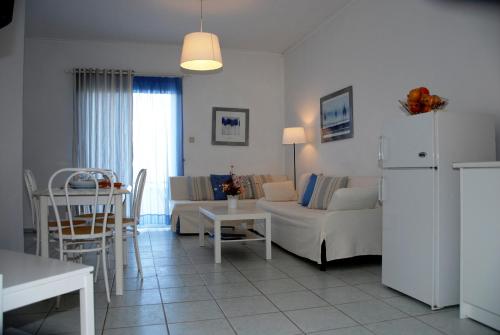 a living room with a couch and a table at Villa Fleria Seaside Studios & Apts in Gerani Chanion