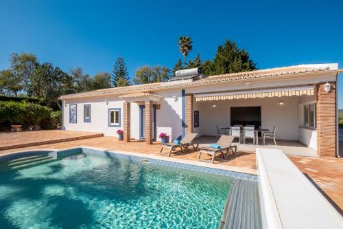 a swimming pool in front of a house at Casa Amada - Private Villa - Heated pool - Free wifi - Air Con in Silves