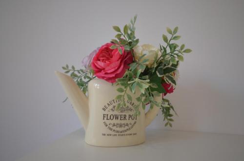 a flower pot with a red rose in it at Blue Sail Sopot Apartments in Sopot