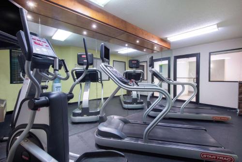 a gym with several treadmills and cardio machines at La Quinta by Wyndham Erie in Erie