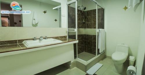 a bathroom with a sink and a shower and a toilet at Hotel Mall Santana Del Río in La Dorada