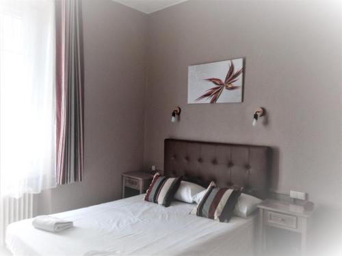 Ένα ή περισσότερα κρεβάτια σε δωμάτιο στο Hotel Astoria