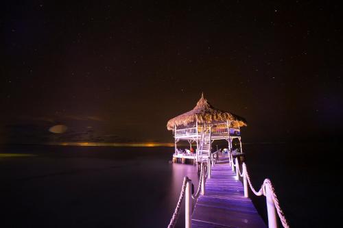 a pier with a gazebo on the water at night at Quinta del Mar Sunset in Isla Mucura