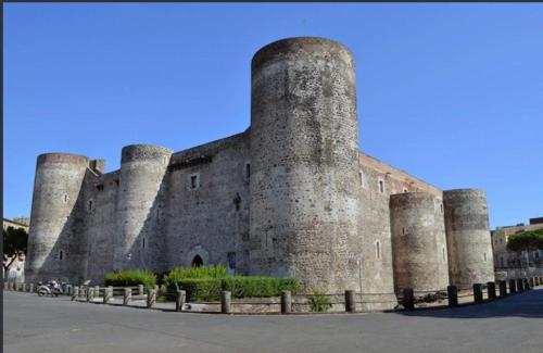 a large stone building with three towers at Little Sicily in Catania