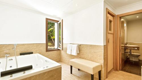 a bathroom with a large tub and a toilet at Villa Marina in Marbella