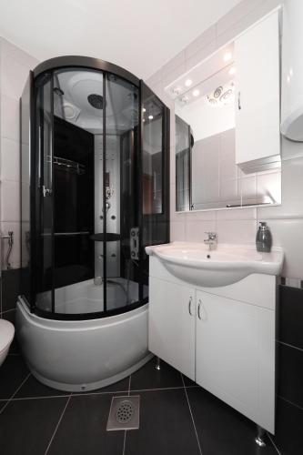 a bathroom with a bath tub and a sink at Apartment Dora in Preko