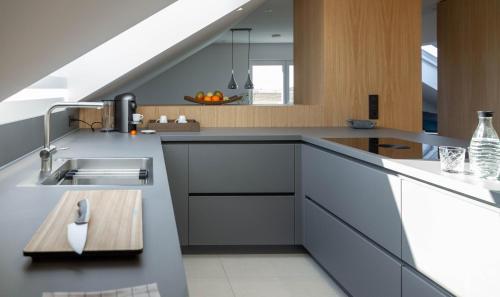 a kitchen with a sink and a counter at Toploft Serviced Apartments in Crailsheim