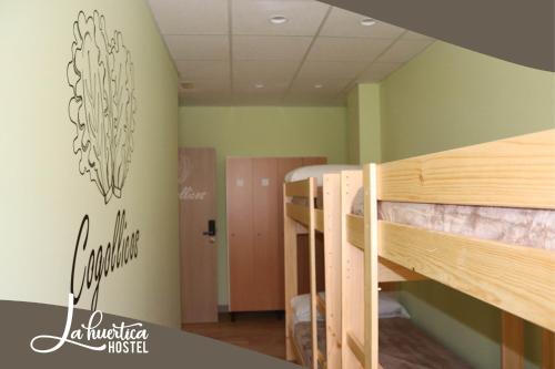 a group of bunk beds in a room at Hostel La Huertica in Valtierra