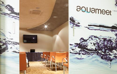 a conference room with a table and chairs at Hotel Aqua in Abano Terme