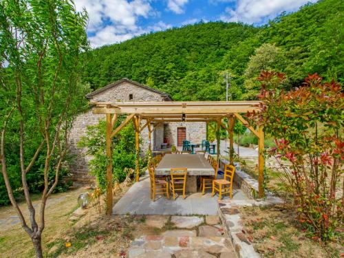 una mesa y sillas bajo una pérgola de madera en Holiday Home La Valchiera by Interhome, en Germagnano