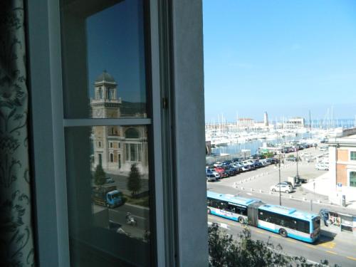 a window with a view of a city with buses at Residence Al Granzo in Trieste
