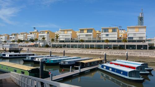 a group of boats docked in a marina with buildings at Tagus Marina in Lisbon