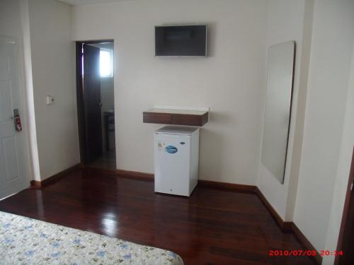 a room with a small refrigerator and a television at Hotel Puesta del Sol in Punta del Este