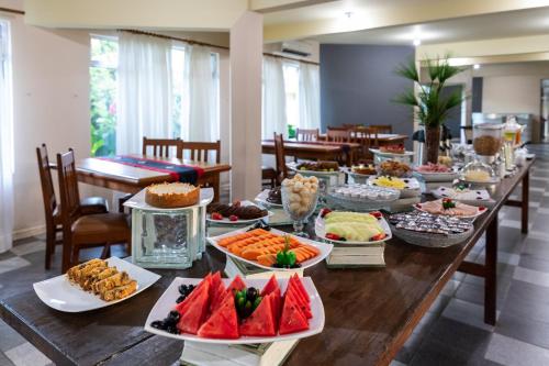 a long table with many plates of food on it at Canzi Cataratas Hotel in Foz do Iguaçu