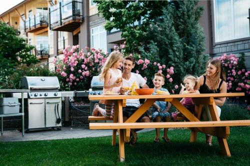 a group of people sitting at a picnic table at Summerland Waterfront Resort & Spa in Summerland