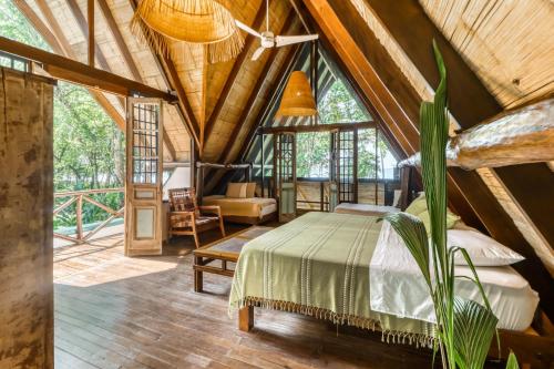 a bedroom in a tree house with a bed at El Ballenato de Bahia #2 in Uvita