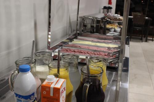 a buffet line with some drinks and some juice at Sleep Hotel in Toledo