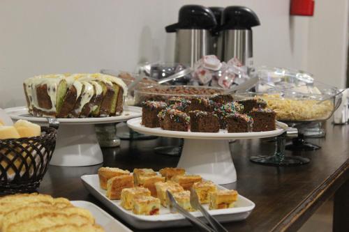 a buffet with different types of cakes and desserts at Sleep Hotel in Toledo