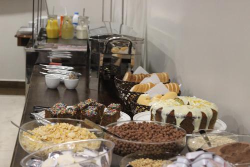 a buffet filled with different types of desserts and cakes at Sleep Hotel in Toledo