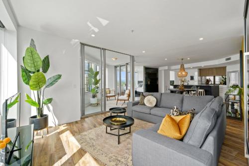 a living room with a couch and a table at Designer Rooms at Q1 resort - gclr in Gold Coast