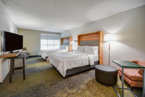 a hotel room with two beds and a flat screen tv at Holiday Inn Allentown-Bethlehem by IHG in Allentown