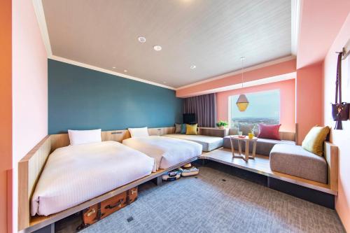 um quarto com 2 camas e um sofá em OMO7 Asahikawa by Hoshino Resorts em Asahikawa