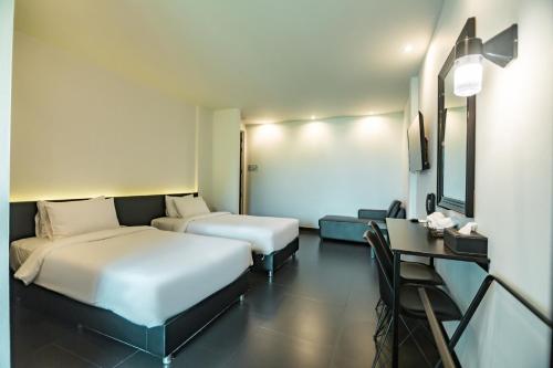 Ένα ή περισσότερα κρεβάτια σε δωμάτιο στο iSilver Hotel