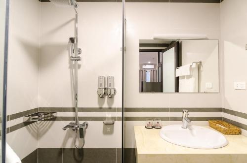 a bathroom with a sink and a shower at Fukurai Hotel & Apartment 2 Ha Noi in Hanoi