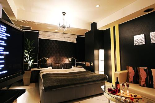 a bedroom with a large bed and a television at HOTEL O2 -Adult Only- in Hirabari