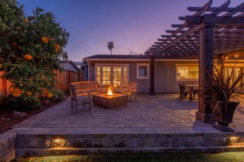 an outdoor patio with a fire pit and a pergola at @ Marbella Lane Executive Waterfront Property in San Mateo
