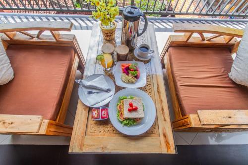 a table with a plate of food on a balcony at Umah Anila in Ubud
