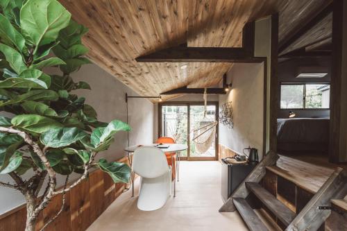 a room with a table and a plant at NIPPONIA Kosuge Village in Kosuge