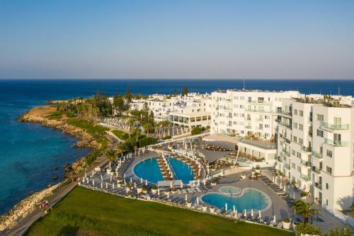 an aerial view of a resort near the ocean at King Jason Protaras - Designed for Adults by Louis Hotels in Protaras