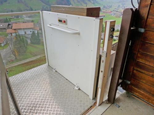 a white refrigerator sitting on top of a balcony at Holiday Home Chalet Guldeli by Interhome in Kandergrund