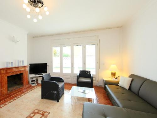 a living room with a couch and chairs and a tv at Holiday Home Requesens by Interhome in Empuriabrava