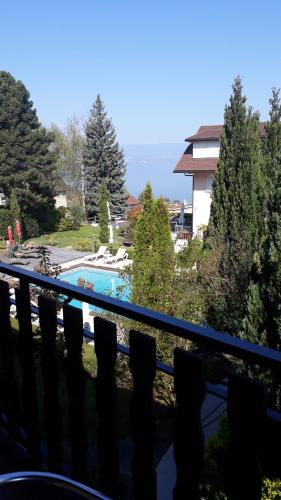 a view from the balcony of a house overlooking the ocean at L'Oasis in Évian-les-Bains