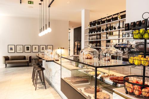 a bakery with a counter with pastries on display at Pillows Grand Boutique Hotel Reylof Ghent in Ghent