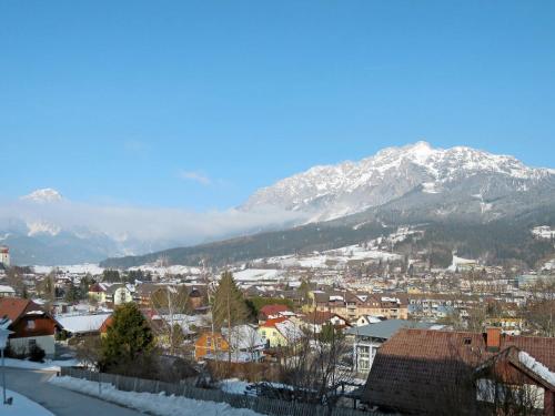 a city with snow covered mountains in the background at Saunahaus Gröbming in Gröbming