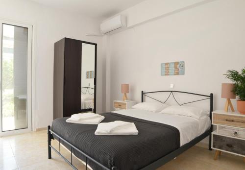 een slaapkamer met een bed met twee handdoeken erop bij Popi's Place in Rhodos-stad
