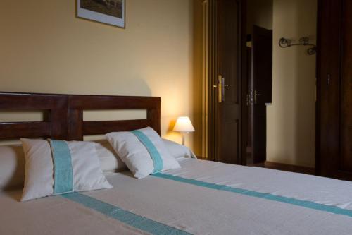 a bedroom with a bed with white and blue pillows at Terremesu a Castiadas Villasimius Costa Rei in Castiadas