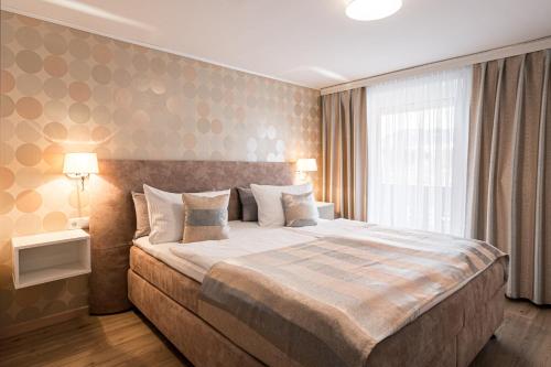 a bedroom with a large bed and a window at bichl 761 in Fischen