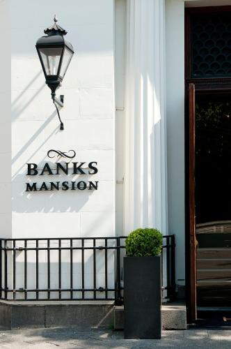 a sign on the side of a building with a lamp at Banks Mansion - Boutique Hotel in Amsterdam