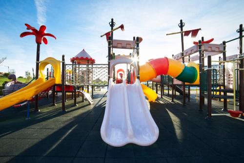 a playground with a slide at a park at RR Alvor Baía Resort in Alvor