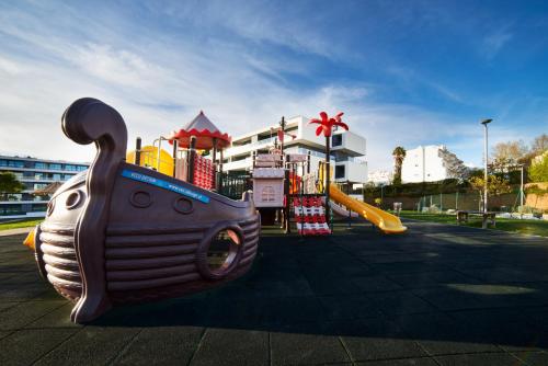 a playground with a slide in a park at RR Alvor Baía Resort in Alvor