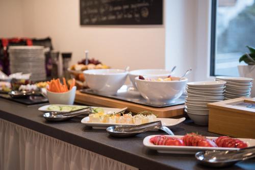a buffet with plates and bowls of food on a table at bichl 761 in Fischen