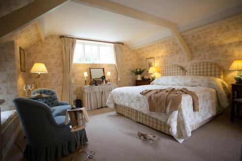 a bedroom with a bed and a chair at Middlethorpe Hall & Spa in York