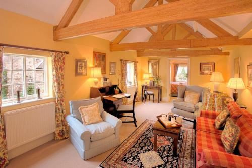 a living room with a couch and chairs and a piano at Middlethorpe Hall & Spa in York
