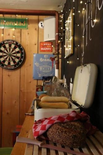 a kitchen counter with a sink and some hot dogs at Hostel Roots in Tilburg