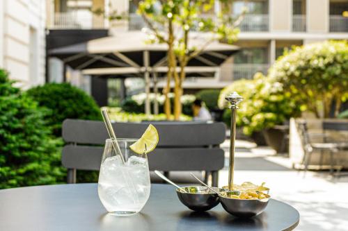 a table with two bowls of food and a drink at Pillows Grand Boutique Hotel Reylof Ghent in Ghent
